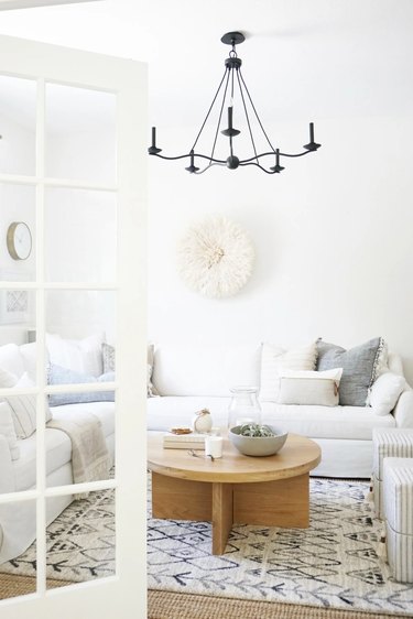 white living room with black chandelier