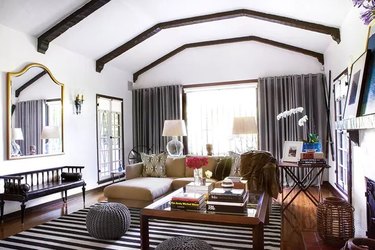 Glam living room with dark exposed beams and luxurious accents