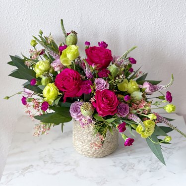arrangement of flowers in off-white vase