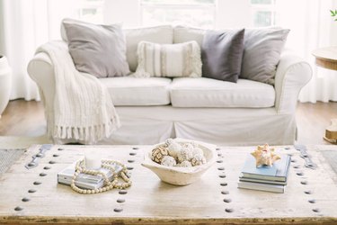 white linen sofar in living room with seashell decor