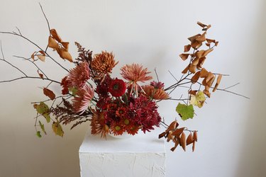 Mums and foraged branches arranged in bowl