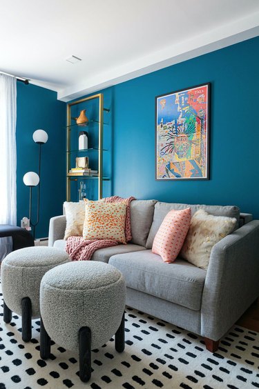 blue and gray living room with "U" shaped floor lamp.