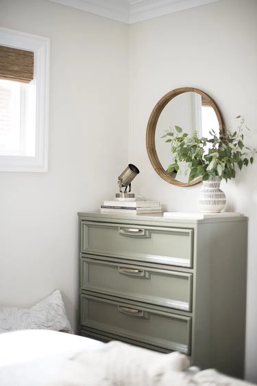 green painted dresser in vintage bedroom