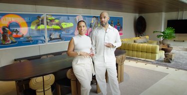 Alicia Keys and Swizz Beatz standing in their dining/living room area