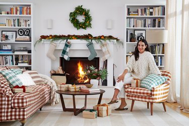 Heather Taylor in holiday-decorated living room with fireplace