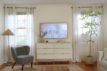 DIY faux shady lady black olive tree in living room with green chair