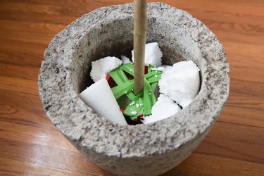 Packing foam wedged inside planter pot to keep faux tree upright