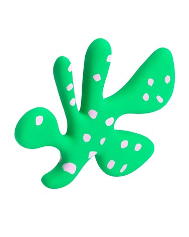 An irregular-shaped dog green dog toy with pink spots.