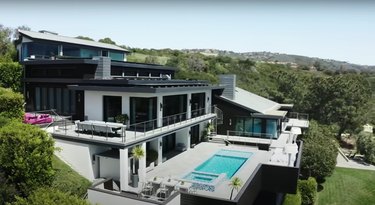 Mansion with a pool surrounded with trees