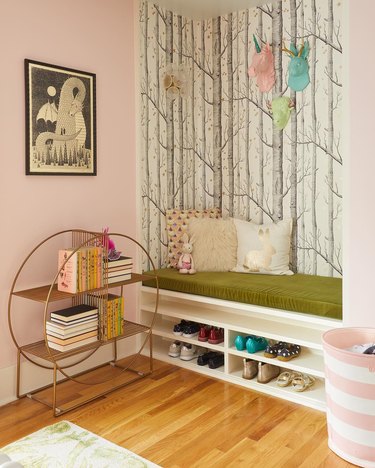 Kids' reading space with whimsical prints and metal bookshelf