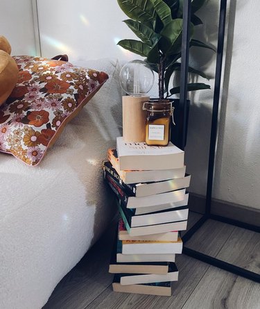 Stack of books with light and candle on top