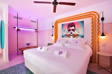 80s themed room with neon lighting, bright colors, and pop art