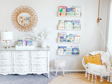 Children's reading room with hanging chair and a white monchrome palette