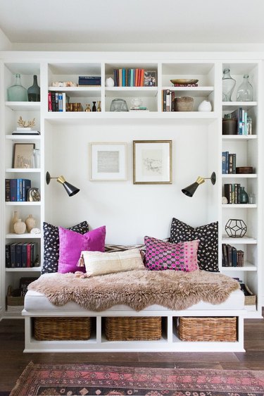 Built in bench surrounded by shelves with books