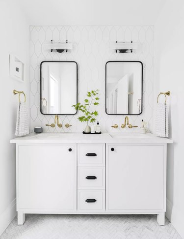 White bathroom vanity with two black mirrors