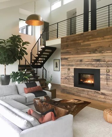Wood panneled firelace wall in a modern living room