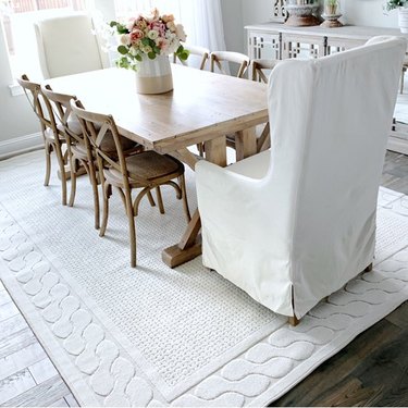 white rug with border in farmhouse dining room