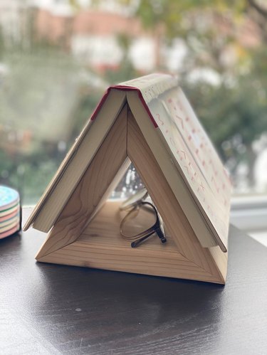 Triangle Bookstand with book and reading glasses.