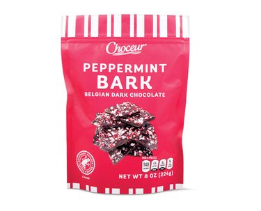 A red package with white text that reads "Choceur Peppermint Bark, Belgian Dark Chocolate" Pictured below the text is a pile of peppermint bark, or square pieces of dark chocolate with crushed peppermint candy on top.