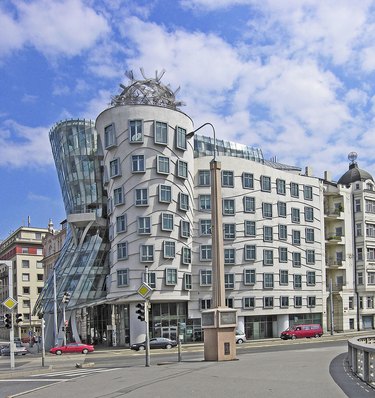 A tall building with many windows on a city block