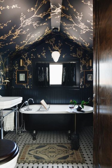 dark bathroom with wallpaper on walls and ceiling