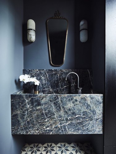 dark blue bathroom with marble sink