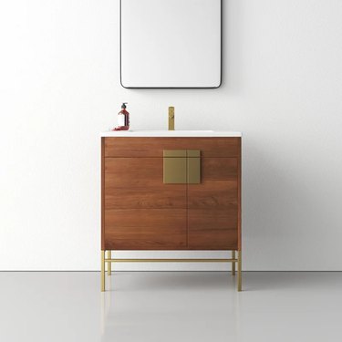 modern wood bathroom vanity with brass detailing