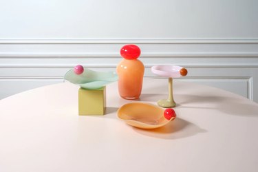 Helle Mardahl tableware in pastel colors on a white table in front of a light wall.