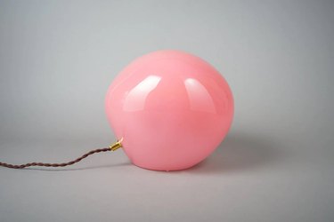 A pink glass blob table lamp