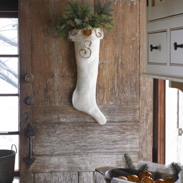 White Christmas stocking hanging on front door.