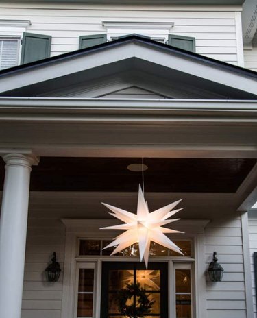 Star lantern hanging over front porch.
