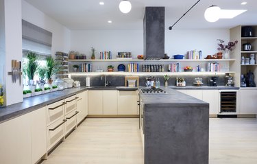 Eitan Bernath's kitchen with a charcoal island in the center and cookbooks lining the back shelves.