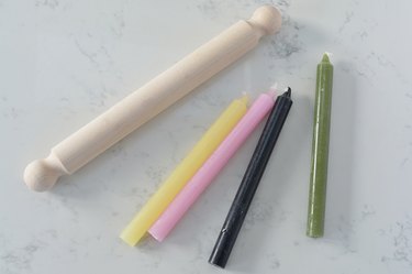 coloured taper candles and rolling pin