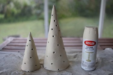 Dried cone trees spray painted with limestone paint