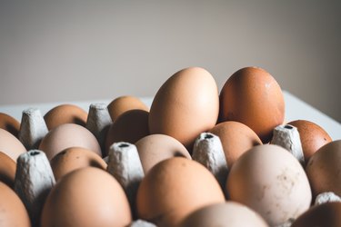 Close-up image of brown eggs in a carton
