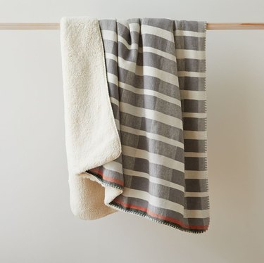 two throw blankets on a hanging rod