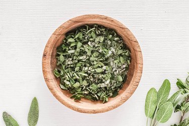 Spices and herbs in a wooden bowl