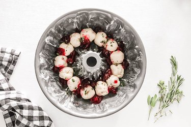 Dough in Bundt pan with herbs and cranberry sauce