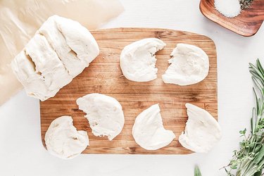 Biscuit dough on a wood cutting board