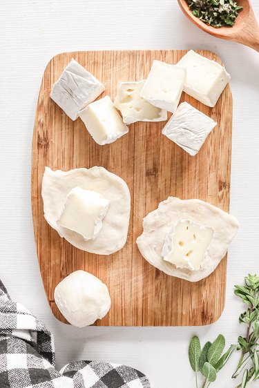 Chunks of brie wrapped in biscuit dough