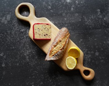 wood serving board with cheese bread and lemons