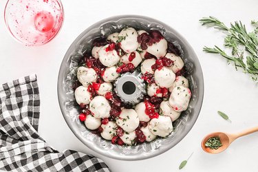 Layer dough, herbs, and cranberry sauce in a Bundt pan