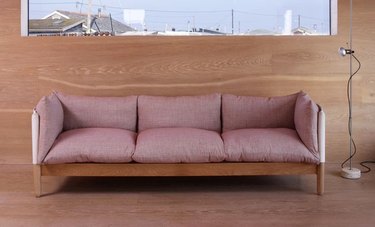 Pink sofa with wood accents