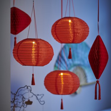 Round red lanterns hanging from a ceiling.