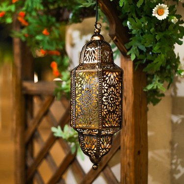Moroccan lantern hanging in a garden