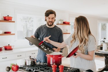 Two people cooking a kitchen