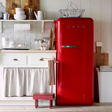 red smeg fridge in rustic farmhouse-style kitchen