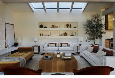 white living room with earth tones and wood coffee table