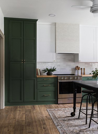 two-tone kitchen color idea with dark green and white cabinetry