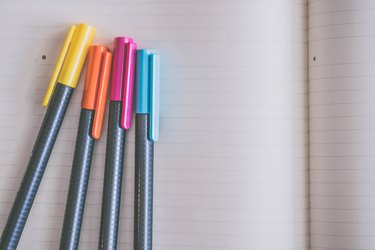Pens on a lined notebook